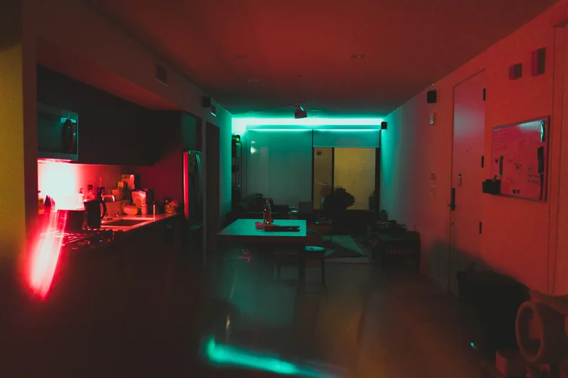 Red and teal lights illuminating a quiet interior.